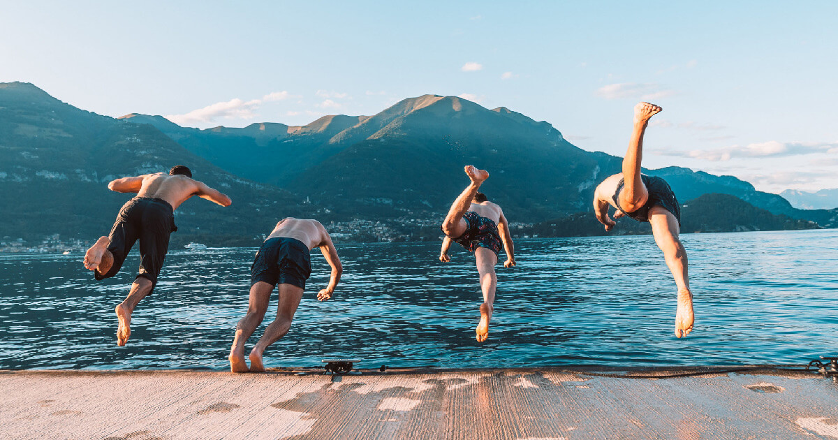 Group of guys dive in lake como